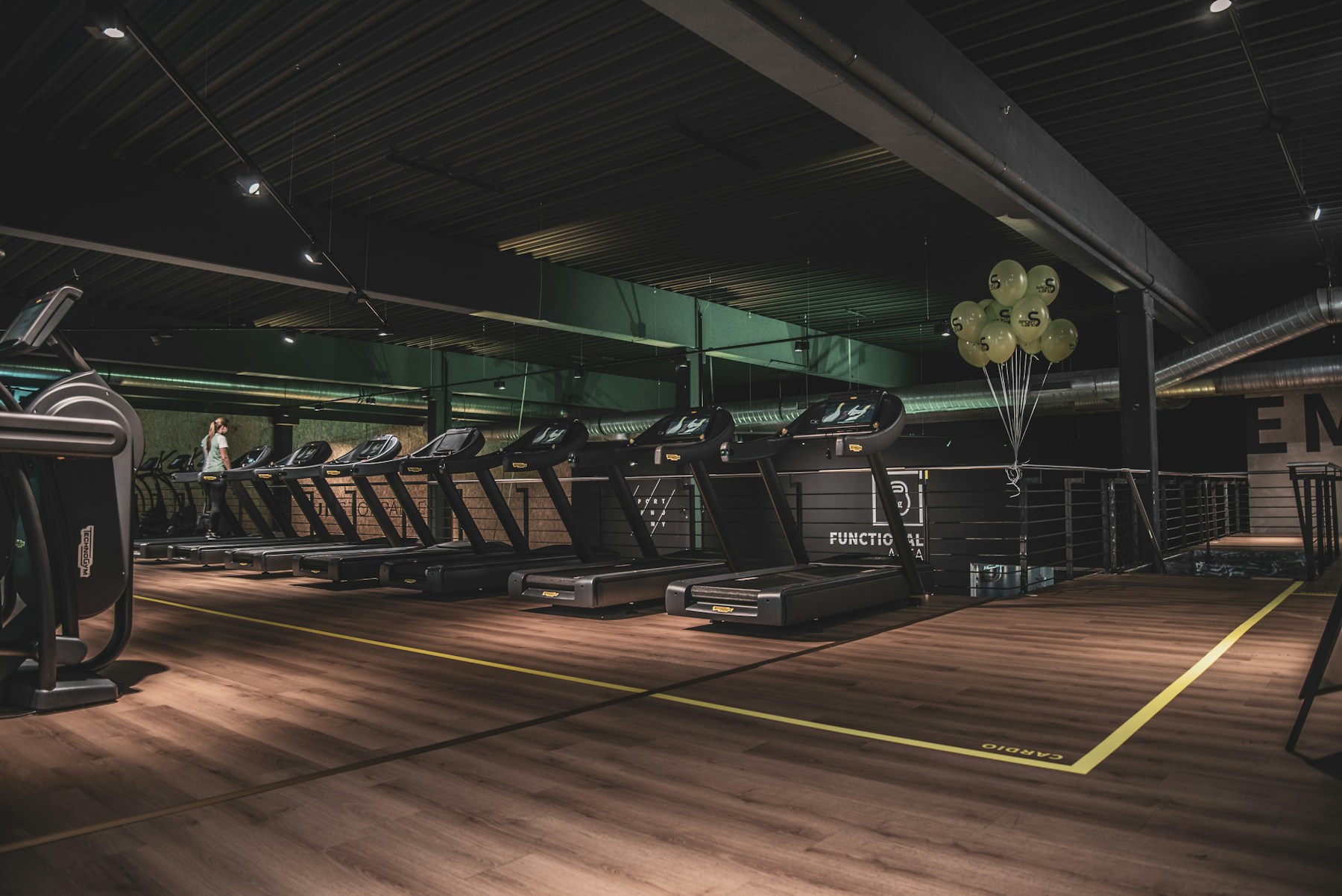 Illustrative gym with rows of treadmills