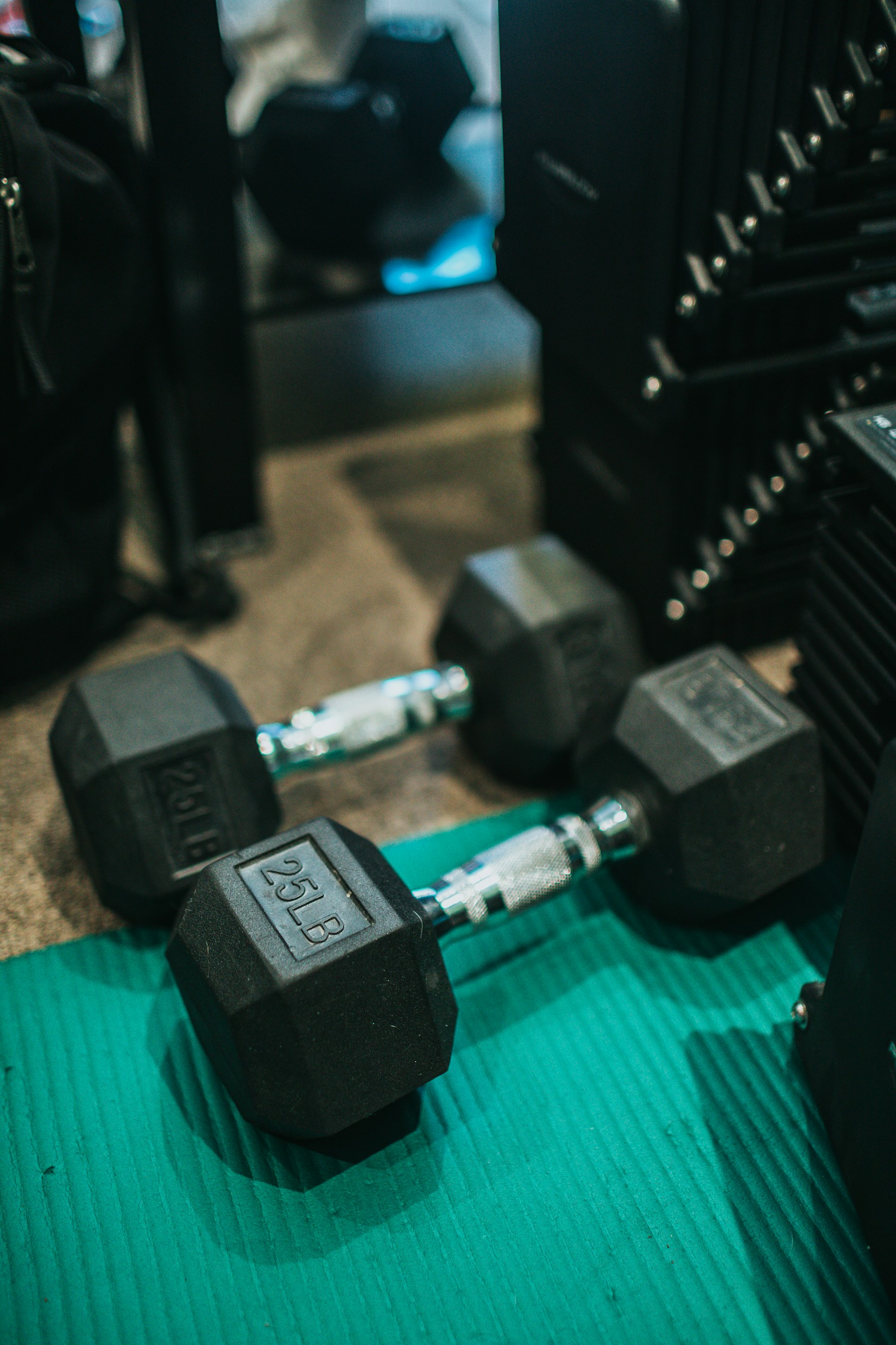 Illustrative photo of black dumbbells on the floor